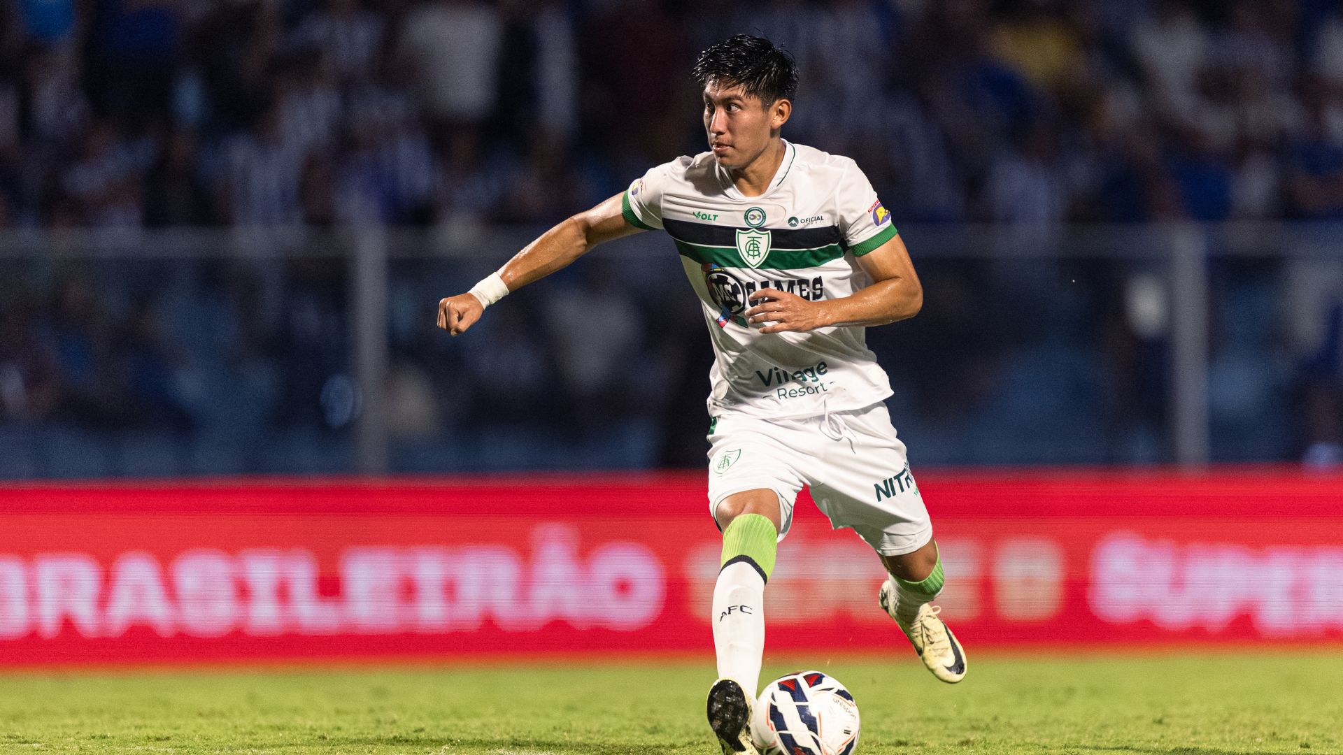 Jogador de futebol com uniforme do América-MG durante uma partida